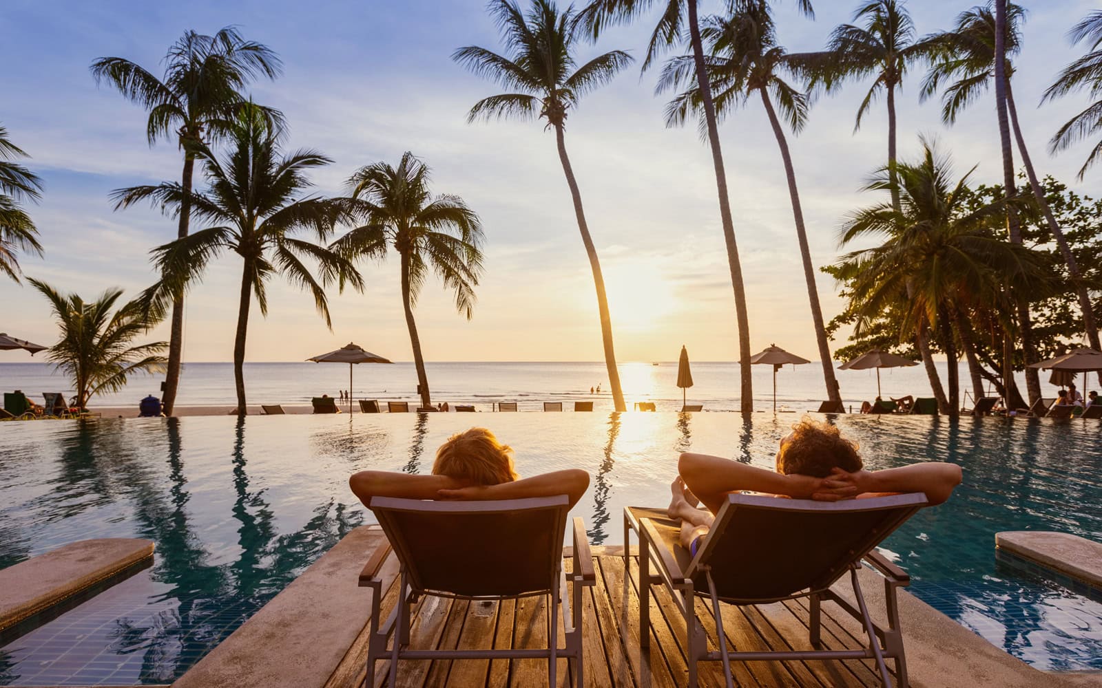 two people lounging by the fall enjoying a sunset