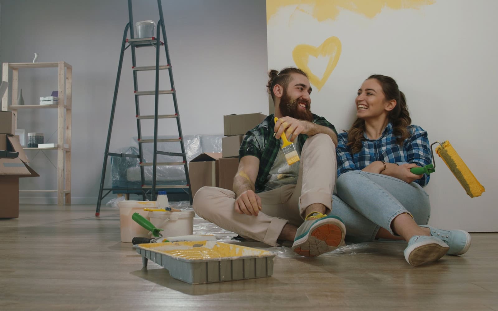 a couple sitting on the floor during a home renovation