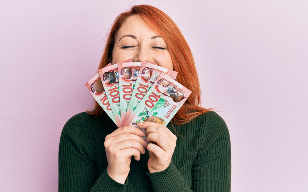 a woman holding fanned out cash in her hands