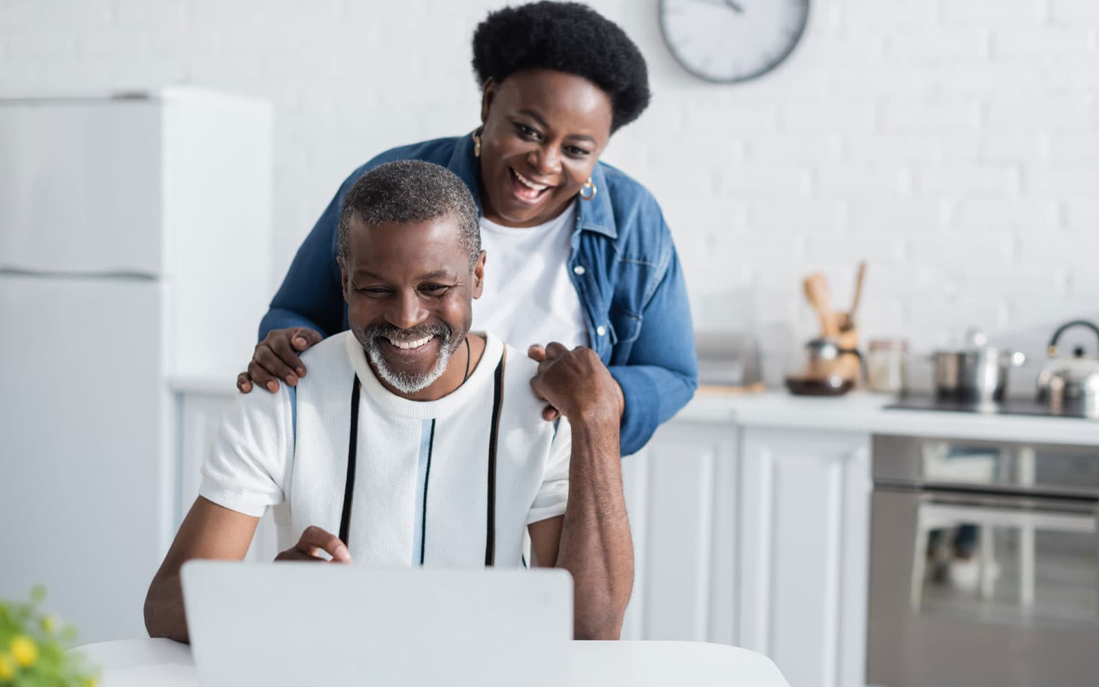 a couple reviewing their loans on their computer